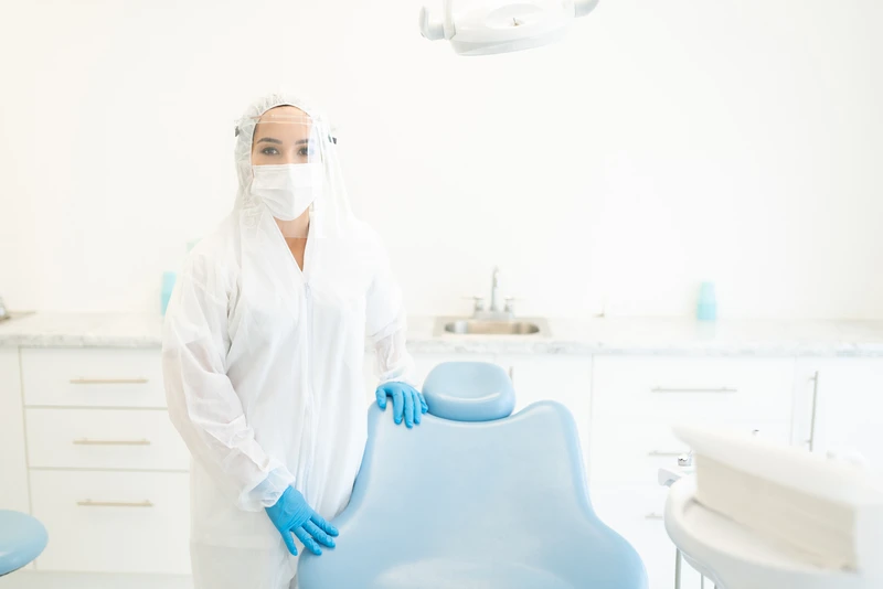 Female dentist wearing face shield and mask during coronavirus outbreak